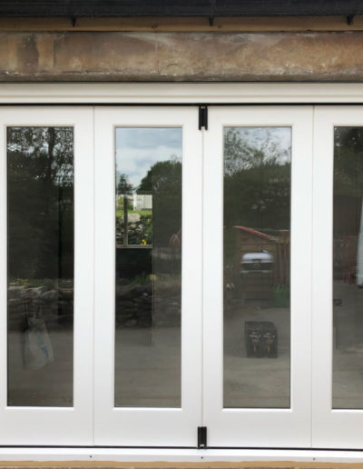 A Set of Bespoke Timber Accoya Bifolding Doors. Made in our Yorkshire Dales Workshop in Rylstone near Skipton, Ilkley, Harrogate and the Ribble Valley. Installed in Hawkswick in the heart of Upper Wharfedale, Craven, near Grassington.