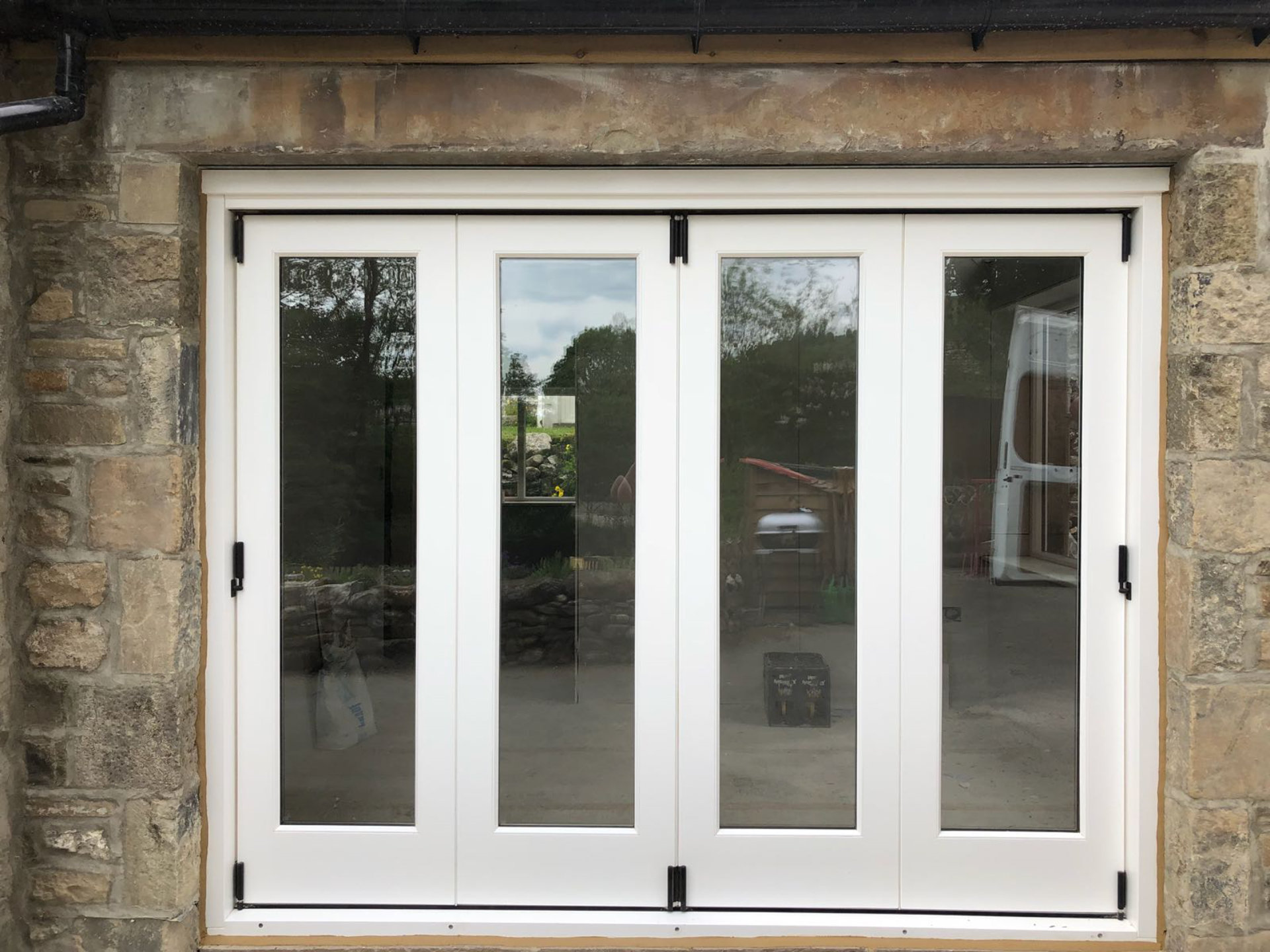 A Set of Bespoke Timber Accoya Bifolding Doors. Made in our Yorkshire Dales Workshop in Rylstone near Skipton, Ilkley, Harrogate and the Ribble Valley. Installed in Hawkswick in the heart of Upper Wharfedale, Craven, near Grassington.