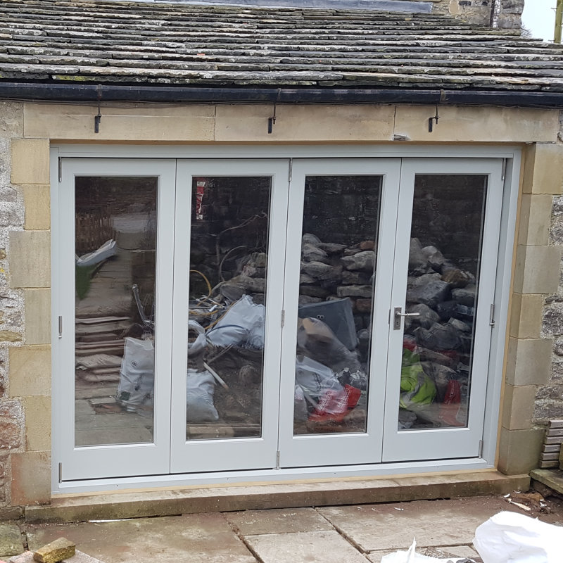 A Set of Bespoke Timber Accoya Bifolding Doors using Centor System. Made in our Yorkshire Dales Workshop in Rylstone near Skipton, Ilkley, Harrogate and the Ribble Valley. Installed in Halton Gill in the heart of Upper Wharfedale, Craven, near Grassington.